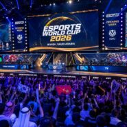 Crowd cheering at the Esports World Cup 2026 Opening Week in Riyadh, Saudi Arabia, with Team Falcons facing T1 on stage
