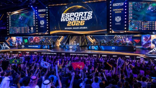 Crowd cheering at the Esports World Cup 2026 Opening Week in Riyadh, Saudi Arabia, with Team Falcons facing T1 on stage